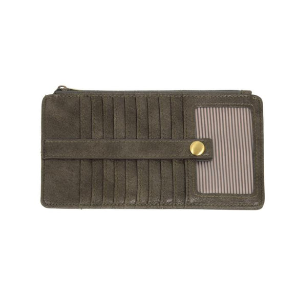 This slim and sleek wallet has nine credit card pockets, each with a snap tab for security and brass-plated hardware. It also has an ID window, zippered change pocket, and zippered billfold pocket in distressed khaki vegan leather.


DIMENSIONS: 3.75 IN. H X 7.25 IN. W X .25 IN. D 


100% Vegan leather (polyurethane)