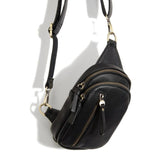 Blending uptown chic with downtown cool, the Skyler sling bag is made in rich vegan black leather! A convertible strap lends versatility, while a front zip pocket offers practical storage for your necessities. It is the perfect companion for a night out on the town or a fun day trip!  8" h x 5.5" w  x 2.25" d
