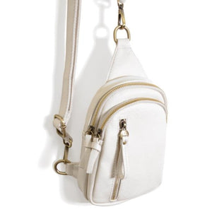 Blending uptown chic with downtown cool, the Skyler sling bag is made in beautiful vegan white-colored leather! A convertible strap lends versatility, while a front zip pocket offers practical storage for your necessities. It is the perfect companion for a night out on the town or a fun day trip!  8" h x 5.5" w  x 2.25" d