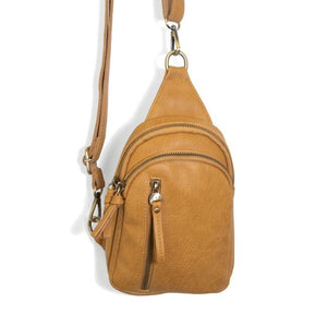 Blending uptown chic with downtown cool, the Skyler sling bag is made in rich vegan mustard yellow leather! A convertible strap lends versatility, while a front zip pocket offers practical storage for your necessities. It is the perfect companion for a night out on the town or a fun day trip!  8" h x 5.5" w  x 2.25" d