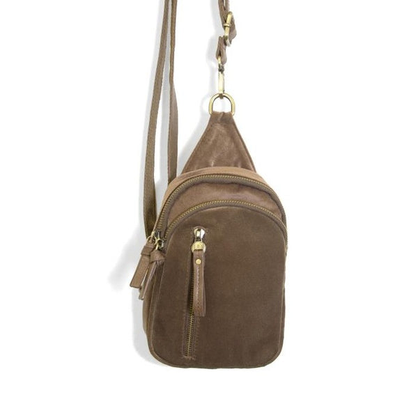 Blending uptown chic with downtown cool, the Skyler sling bag is made in beautiful coco-colored velvet! A convertible strap lends versatility, while a front zip pocket offers practical storage for your necessities. It is the perfect companion for a night out on the town or a fun day trip!  8