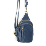 Blending uptown chic with downtown cool, the Skyler sling bag is made in beautiful sapphire blue velvet! A convertible strap lends versatility, while a front zip pocket offers practical storage for your necessities. It is the perfect companion for a night out on the town or a fun day trip!  8" h x 5.5" w  x 2.25" d