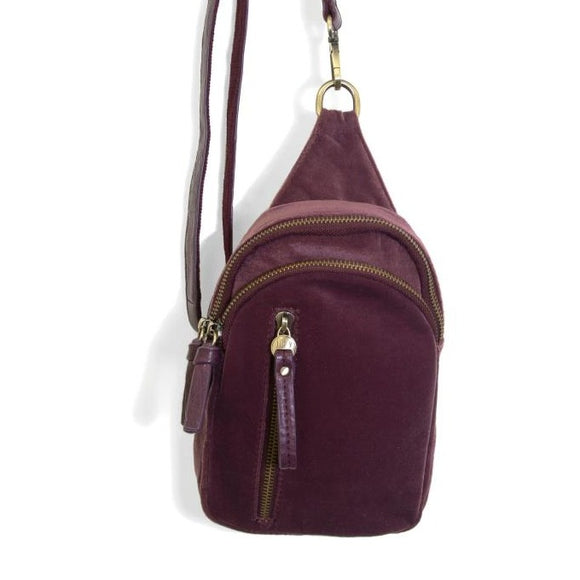 Blending uptown chic with downtown cool, the Skyler sling bag is made in beautiful plum velvet! A convertible strap lends versatility, while a front zip pocket offers practical storage for your necessities. It is the perfect companion for a night out on the town or a fun day trip!  8