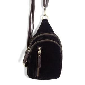 Blending uptown chic with downtown cool, the Skyler sling bag is made in beautiful espresso colored velvet! A convertible strap lends versatility, while a front zip pocket offers practical storage for your necessities. It is the perfect companion for a night out on the town or a fun day trip!  8" h x 5.5" w  x 2.25" d