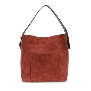 Equally timeless and modern, our best-selling classic hobo is made in rich vegan leather in a beautiful rust faux suede, accented with a brown strap.&nbsp; This roomy bag, accented with a large front pocket and a snap-in removable brown crossbody, has plenty of room to carry your needs in style.