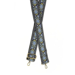 Let your boho side show!  Give your bag a POP with this guitar strap! Colors of yellow, turquoise blue, and periwinkle blue are on a black background.  The back of the strap is solid black.  2" wide 35-54" adjustable length Brass plated hardware 100% cotton