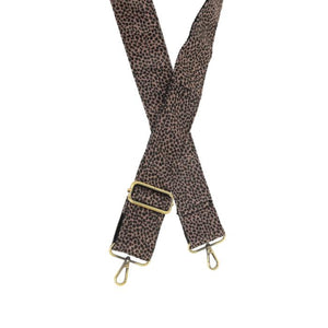 Express your style and add playful hints of pattern with this raisin colored cheetah pattern on a black background to your favorite cross-body or clutch with this guitar strap! The back of the strap is black.

2" wide

35-54" adjustable length

Brass plated hardware

100% Cotton