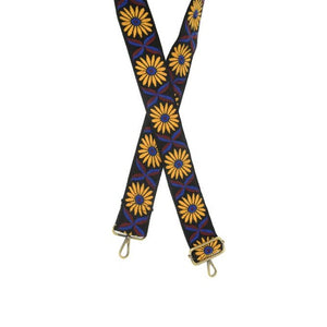 Do you want to SPARK a little STYLE this season?  Add a fun new guitar strap to your purse!  This 2" strap is full of character with its stunning mustard yellow daisies and royal blue and burgundy leaves in between each flower, all on a black strap. The back of the strap is a solid black. 2" wide  Adjustable 35-54" in length  Embroidered cotton   Antique brass hardware