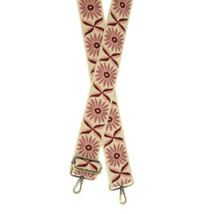 You'll love changing up the style of your purse with one of our guitar straps! This cream woven strap has mauve-colored daisies going down it - so cute! The back of the strap is solid cream.  35"-54" adjustable length  2" wide  Brass plated hardware