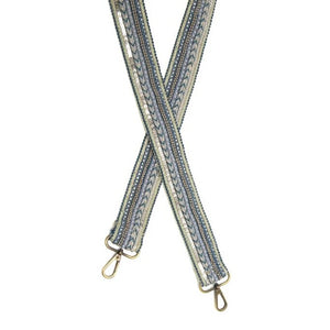 Bling it up with this fun guitar strap!&nbsp; Different shades of teals are embellished with pearlized beads, silver beads, silver sequins, and a strand of pretty rhinestones in a fantastic stripe pattern going down this strap.    1.5" wide  35-54" adjustable length  Brass plated hardware  100% Cotton backing