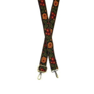 This gorgeous guitar strap will get people talking!  This black strap has gorgeous gold and magenta flowers scattered in olive vines.  The back of this strap is black.  1.25" wide  35"-54" adjustable length  80% Polyester 20% Cotton  Brass plated hardware 