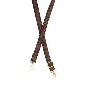 You'll love changing up the style of your purse with one of our guitar straps! This black strap has a beautiful geometric tulip print in reds, olive greens, and golden brown!  The back of the strap is black    35"-54" Adjustable length   1.2" wide  Brass plated hardware