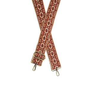 You'll love changing up the style of your purse with one of our guitar straps! This fun rust-colored 2" strap has a fun diamond design in white, blue, and red colors.  The back of the strap is a cream tweed.  35"-54" Adjustable length   2" wide  Brass plated hardware