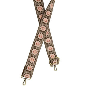 We are loving this new strap!  It has a brown background and has the most adorable pink rosettes with a red accent in the center going down the strap! You'll express your style by mixing it with your favorite crossbody bag!   2" wide  35-54" adjustable length  Brass plated hardware  100% Cotton