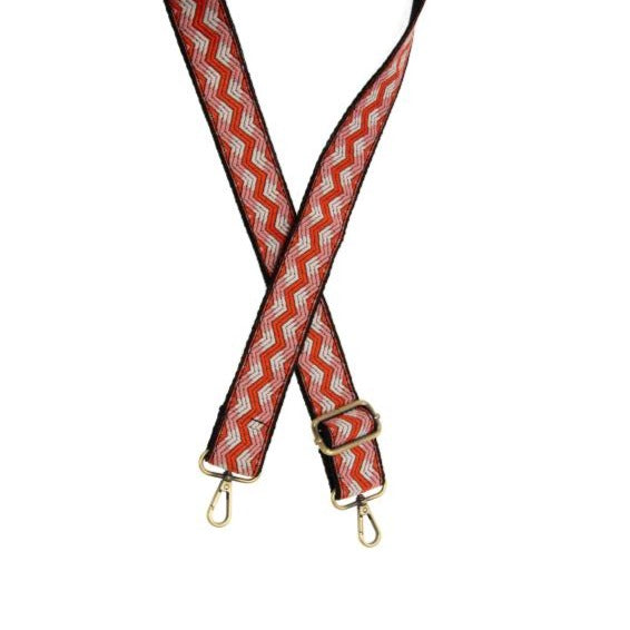 You'll love changing up the style of your purse with one of our guitar straps! This black strap has an adorable orange, white, and pink chevron design going down the strap. The back of the strap is solid black.  35