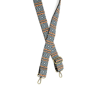 Give your purse or crossbody a fresh look with a new strap! This strap has a black background with turquoise and white triangles going down. In between the triangle designs are orange, turquoise, black and white stripes. The back of the strap is black.

1.5" wide

35-54" adjustable length

Brass plated hardware

100% Cotton