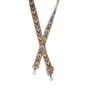 Give your purse or crossbody a fresh look with a new strap! This strap has a brown background with a turquoise, white, cobalt and black dotted chevron pattern. The back of the strap is brown.

1.2" wide

35-54" adjustable length

Brass plated hardware

100% Cotton