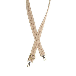 You'll love how this tan strap with a white border with white geometric pyramids in the center freshens up your currant purse or crossbody! The back of the strap is cream.

1.2" wide

35-54" adjustable length

Brass plated hardware

100% Cotton