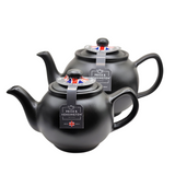 When it's time for a spot of tea, reach for one of our stoneware teapots, which can absorb the heat of boiling water without cracking. Likewise, the beautiful exterior is protected with a gloss to prevent the paint from warping or rippling. The classic bulbous shape allows tea leaves or bags to move freely for just the right amount of flavoring.&nbsp;

The matte black teapot is available in 2-cup or 6-cup size