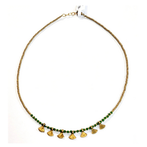 This gold beaded necklace with green glass beads has 7 gold triangle shapes hanging from the bottom. It is pretty to wear alone but looks great layered with one of our longer brass necklaces!

Handmade by a young designer and team of artists in Northern India.

17"-18" Adjustable necklace&nbsp;