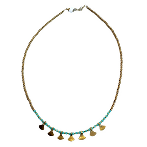 This gold beaded necklace with&nbsp;turquoise glass&nbsp;beads has 7 gold triangle shapes hanging from the bottom. It is pretty to wear alone but looks great layered with one of our longer brass necklaces!

Handmade by a young designer and team of artists in Northern India.

17"-18" Adjustable necklace&nbsp;