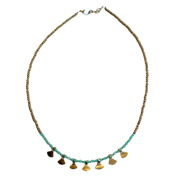 This gold beaded necklace with turquoise glass beads has 7 gold triangle shapes hanging from the bottom. It is pretty to wear alone but looks great layered with one of our longer brass necklaces!

Handmade by a young designer and team of artists in Northern India.

17