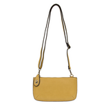 Our most popular bag, in a beautiful butter yellow color, this mini clutch, with its sleek silhouette, is as gorgeous as it is versatile.&nbsp; Features include a polished turn lock, six card slots, and an interior zipper for change.&nbsp; It can be styled in many ways, with removable straps for alternating between wallet, crossbody, and wristlet!

&nbsp;5"H x 9.5"W x 1"D

Removable and adjustable crossbody strap 13"-24"

Wristlet strap 7" long

interior zippered pocket

brass plated hardware

100% vegan le