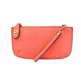 Our most popular bag, in a beautiful watermelon color, this mini clutch, with its sleek silhouette, is as gorgeous as it is versatile.&nbsp; Features include a polished turn lock, six card slots, and an interior zipper for change.&nbsp; It can be styled in many ways, with removable straps for alternating between wallet, crossbody, and wristlet!

&nbsp;5"H x 9.5"W x 1"D

Removable and adjustable crossbody strap 13"-24"

Wristlet strap 7" long

interior zippered pocket

brass plated hardware

100% vegan leath