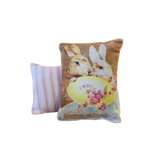 This adorable mini vintage postcard pillow has a brown and white bunny leaning on a yellow egg with "Greeting At Easter" below. You'll love to find a spot to tuck this cute Easter pillow in!

&nbsp;7" H x 5" W

Cotton