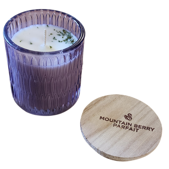 You'll love our newest cathedral glass tumbler! This mountain berry parfait scent has been poured into a pretty purple patterned glass and comes with a wooden lid.

Wild blueberries, red raspberries, peach and strawberry fuse together with fresh coconut, condensed milk, orange zest and sweet cream for a bright and buttery berry confection!

Filled with 6.5 oz. of American Soybean WaxTM. Measures 3.25