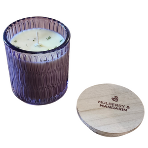 You'll love our newest cathedral glass tumbler! This mulberry mandarin scent has been poured into a pretty purple patterned glass and comes with a wooden lid.

Pure mulberry jam with a nice mandarin orange zest makes this a fruit fragrance all will enjoy!

Filled with 6.5 oz. of American Soybean WaxTM. Measures 3.25"W x 3.75 "H (with lid) with a 35+ hour burn time