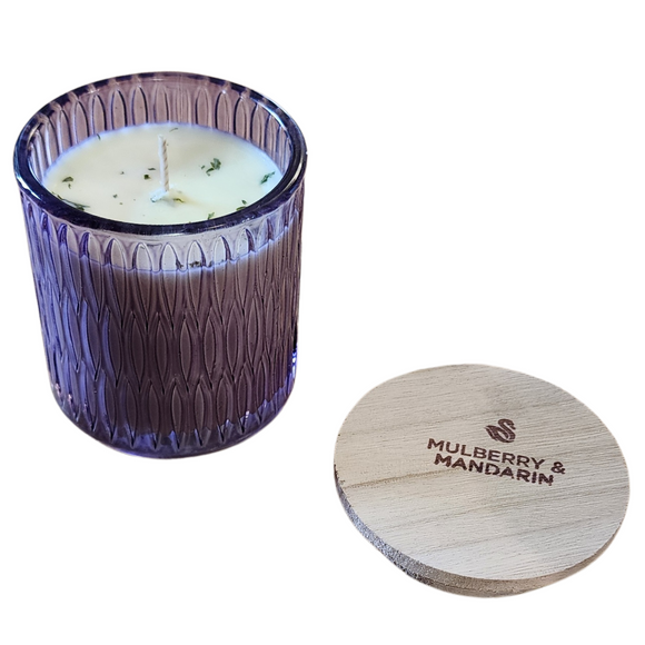 You'll love our newest cathedral glass tumbler! This mulberry mandarin scent has been poured into a pretty purple patterned glass and comes with a wooden lid.

Pure mulberry jam with a nice mandarin orange zest makes this a fruit fragrance all will enjoy!

Filled with 6.5 oz. of American Soybean WaxTM. Measures 3.25
