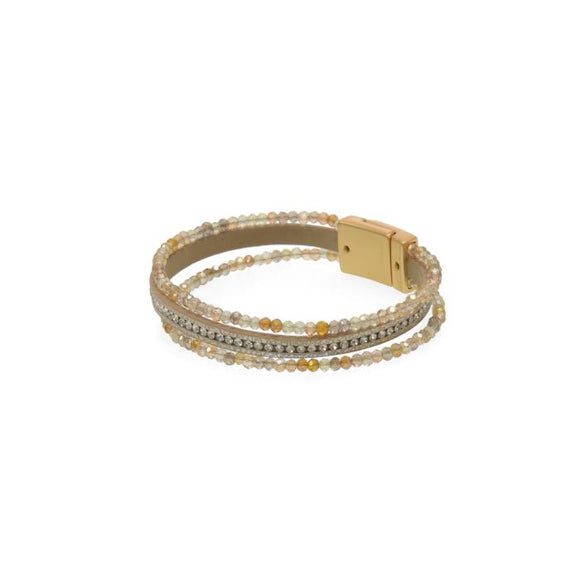 You'll love how easy it is to put this magnetic clasp bracelet on and take off!  This bracelet has two glitzy gold, clear and greyish beaded strands on either side of a cream leather band with a sparkly strand in the center of it.

Approximately 1/2