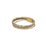 You'll love how easy it is to put this magnetic clasp bracelet on and take off!&nbsp; This bracelet has two glitzy gold, clear and greyish beaded strands on either side of a cream leather band with a sparkly strand in the center of it.

Approximately 1/2" W x&nbsp; 7.75" L