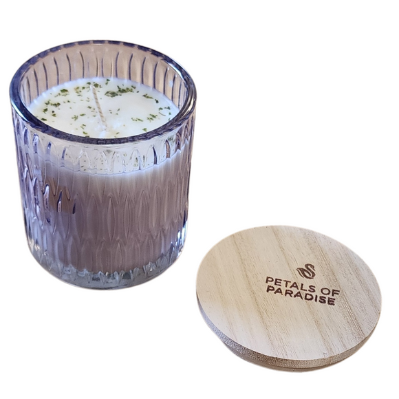 You'll love our newest cathedral glass tumbler! This petals of paradise has been poured into a pretty purple patterned glass and comes with a wooden lid.

This incredible fragrance is like steeping into a garden paradise with tropical florals and a hint of mandarin orange.

Filled with 6.5 oz. of American Soybean WaxTM. Measures 3.25