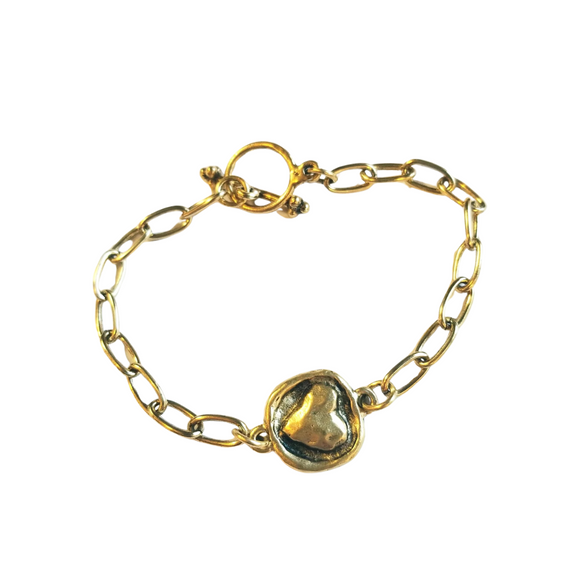 This simple, but elegant bracelet has pretty gold link chains on either side of a beautiful gold embossed heart and has a toggle closure. It is the perfect size to wear every day and can be worn alone or with other bracelets.

7