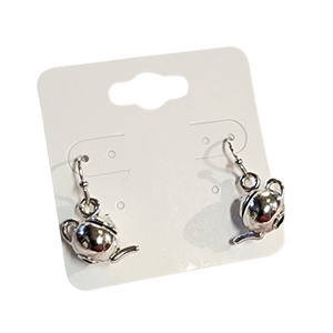 Warm up your style with these teatime treasures. These adorable silver earrings shaped like round vintage teapots, capturing the charm of an old-world tea party. Perfect for those who love a touch of nostalgia and a sprinkle of whimsy in their everyday style.

Measures approximately 3/4". Teapot is 1/2" in height

Materials: Silver Tone Metal