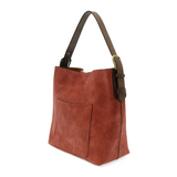 Equally timeless and modern, our best-selling classic hobo is made in rich vegan leather in a beautiful rust faux suede, accented with a brown strap.&nbsp; This roomy bag, accented with a large front pocket and a snap-in removable brown crossbody, has plenty of room to carry your needs in style.