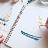 Watercolor workbooks are just like a coloring book, but with watercolor! Enjoy this peaceful hobby on your own, with kids, and with friends. Makes a wonderful gift. Perfect for artists of any age. This Seaside book has beautiful illustrations of boats, crabs, anchors, oars and more for you to paint!

12 beginner-friendly, lightly sketched illustrations

Simple step-by-step instructions and example

Lay flat spiral pages for easy painting

Durable 120 lb watercolor paper

Travel ready 6.5 inch x 9 inch size
