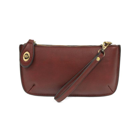 Our most popular bag, this mini clutch, with its sleek silhouette, is as gorgeous as it is versatile.  Features include a polished turn lock, six card slots, and an interior zipper for change.  It can be styled in many ways, with removable straps to alternate between wallet, crossbody, and wristlet!   5