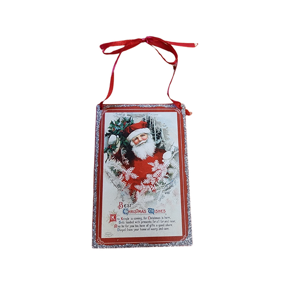 Bring a little nostalgia to your holiday decor this year with this rectangle shaped vintage ornament that has Santa holding holly and says 