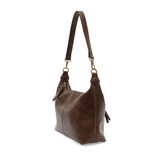 The Danna crossbody is masterfully crafted in our gorgeous new tumbled gloss vegan hickory leather to give your look a polished yet casual vibe. Fitted with a top zip closure accented by our signature logo zip pull and two removable and interchangeable shoulder straps; a short shoulder strap to wear snug to the body or a long adjustable, removable crossbody shoulder strap to wear as a crossbody, this slouchy hobo design is perfect for your everyday style.


Dimensions: 9.5 in. H X 10.5 in. W X 3.5 in. D
Top