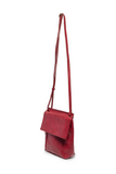 With a slim, streamlined look, this vegan leather crossbody, in a beautiful cranberry color, features a top flap with magnetic snap closure and an adjustable shoulder strap so you can carry it as a crossbody or a shoulder bag. With two convenient slip pockets, one under the flap and one on the back you can keep your phone and keys in easy reach.


Dimensions: 9.5 in. H x 8 in. W x 2.75 in. D
Magnetic snap closure
Adjustable shoulder strap: 14 in. - 27.5 in. drop
Brass plated hardware
100% Vegan leather (pol