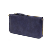 Cool, stylish, and organized, too! This wallet has it all! 12 credit card pockets, 2 change pockets and 2 billfold pockets all wrapped in a dark oak&nbsp;colored vegan leather, lined with rugged washed canvas, and accented with our new Logo zipper pull. The removable strap lets you carry it as a compact wristlet, too!


Dimensions: 7.75 in. W x 4 in. H x .5 in. D
Full Zip Around Closure
Exterior Zip Pocket on Spine
Removable Wristlet Strap
12 Credit Card Pockets
2 Billfold Pockets
Interior Zipper
Coin Pocke