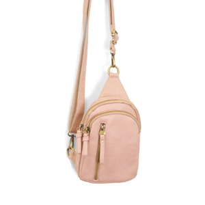 Blending uptown chic with downtown cool, the Skyler sling bag is made in rich rose quartz vegan leather! A convertible strap lends versatility, while a front zip pocket offers practical storage for your necessities. It is the perfect companion for a night out on the town or a fun day trip!


8" h x 5.5" w&nbsp; x 2.25" d
Removable and adjustable convertible strap 20"-30" drop
Zippered top closure
Exterior front zip pocket
2 exterior zip compartments
4 interior credit card pockets
Brass plated hardware
100% 