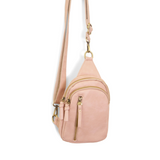 Blending uptown chic with downtown cool, the Skyler sling bag is made in rich rose quartz vegan leather! A convertible strap lends versatility, while a front zip pocket offers practical storage for your necessities. It is the perfect companion for a night out on the town or a fun day trip!


8" h x 5.5" w&nbsp; x 2.25" d
Removable and adjustable convertible strap 20"-30" drop
Zippered top closure
Exterior front zip pocket
2 exterior zip compartments
4 interior credit card pockets
Brass plated hardware
100% 
