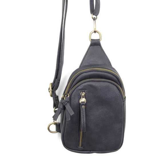 Blending uptown chic with downtown cool, the Skyler sling bag is made in deep charcoal vegan leather! A convertible strap lends versatility, while a front zip pocket offers practical storage for your necessities. It is the perfect companion for a night out on the town or a fun day trip!


8