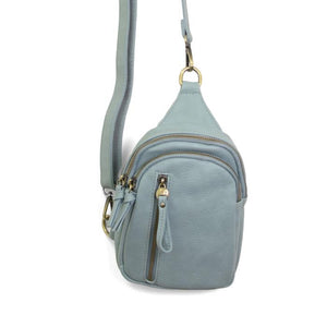 Blending uptown chic with downtown cool, the Skyler sling bag is made in rich vegan light denim leather! A convertible strap lends versatility, while a front zip pocket offers practical storage for your necessities. It is the perfect companion for a night out on the town or a fun day trip!


8" h x 5.5" w&nbsp; x 2.25" d
Removable and adjustable convertible strap 20"-30" drop
Zippered top closure
Exterior front zip pocket
2 exterior zip compartments
4 interior credit card pockets
Brass plated hardware
100% 