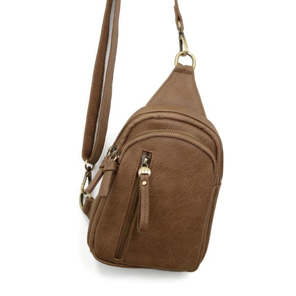 Blending uptown chic with downtown cool, the Skyler sling bag is made in rich vegan taupe leather! A convertible strap lends versatility, while a front zip pocket offers practical storage for your necessities. It is the perfect companion for a night out on the town or a fun day trip!   8