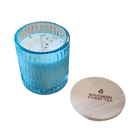 You'll love our newest cathedral glass tumbler! This southern sweet tea scent has been poured into a pretty blue patterned glass and comes with a wooden lid.

Notes of Meyer lemon, English black tea, bergamot and Louisiana sugar cane for a rich, warm and sweet aromatic experience. Perfect for any time of the year!

Filled with 6.5 oz. of American Soybean WaxTM. Measures 3.25